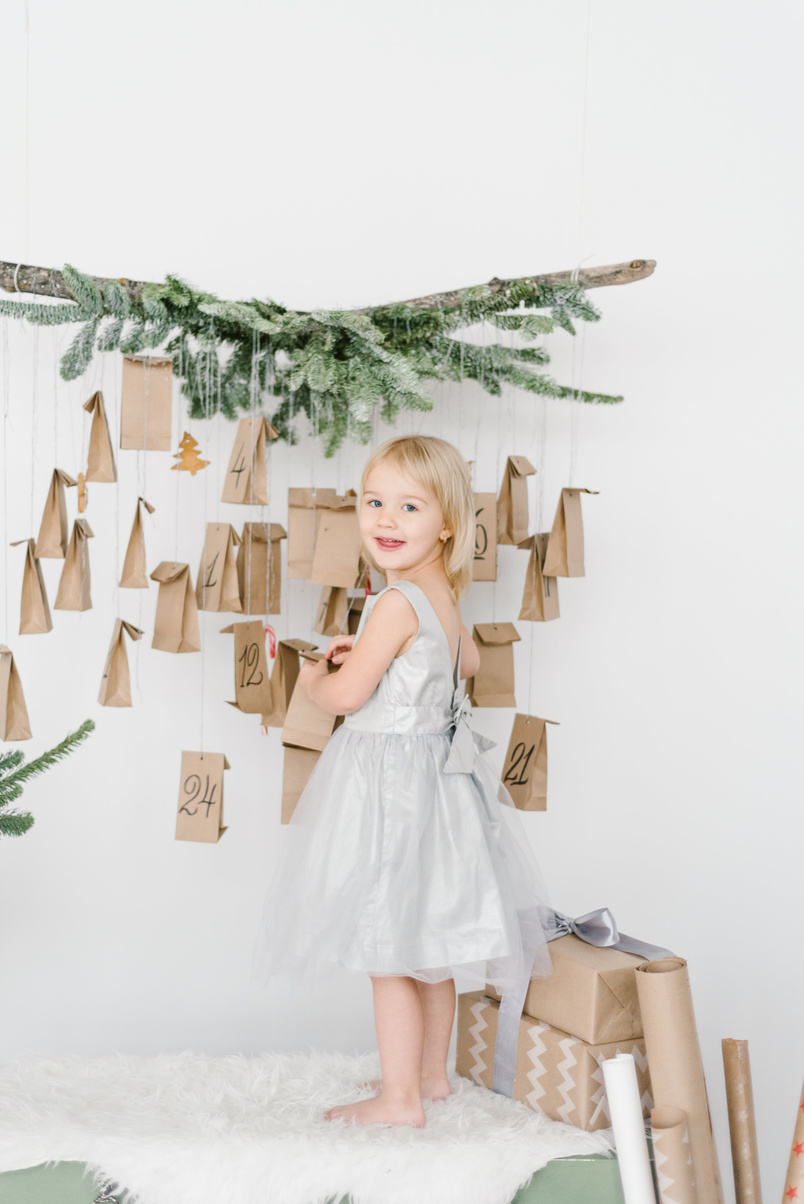 Happy girl decorating house with Christmas theme